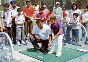 Coach Ajay Gujral gives basic golf training to young non-members at the Chandigarh Golf CLub