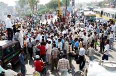 Members of Gurjar community block a road in East Delhi on Wednesday to protest against police firing on Gurjars in Rajasthan