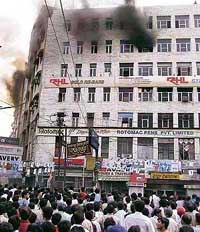 People gather outside City Centre Mall which caught fire in Kanpur on Wednesday.