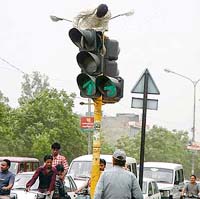 Daredevil or a PSEB employee: An employee repairs a traffic light pole in Ludhiana
