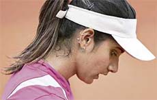 Sania Mirza reacts after losing to Serbias Ana Ivanovic at the French Open in Paris on Thursday. Sania lost 1-6, 4-6. 