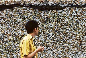 This smoker can’t seem to take his eyes off a pile of cigarettes. The glass art display of 10,000 cigarettes was part of a World No Tobacco Day campaign.