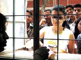 Students queue up to submit their admission forms on the first day in a Delhi University North campus college on Friday.