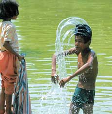 A boy is beating the heat at India Gate in the Capital on Friday.