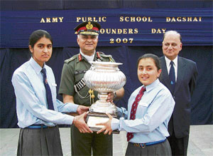 Lieut-Gen Daljeet Singh, GoC-in-C, Western Command, gives away a trophy to the winners at the founders day of Army Public School, Dagshai, on Friday.