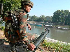 A jawan near the site of an IED blast triggered by militants at an Army convoy at Rajbagh in Srinagar on Friday.