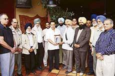 Radio India managing director Maninder Singh Gill honours Amrik Singh Gill in Surrey, Canada.