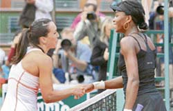 Serbias Jelena Jankovic (left) shakes hands with USAs Venus Williams after winning their third-round match during the French Open in Paris