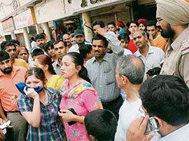 People gather around a victim after a purse-snatching incident in Chandigarh on Saturday.