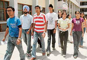 Students come out of a centre after taking the PTU CET at Guru Gobind Singh College, Sector 26, in Chandigarh on Saturday.