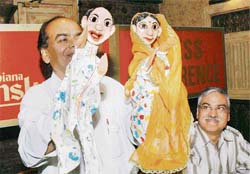 Sham Mali making two puppet characters to play