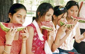 SUMMER SPECIAL: Girls enjoy watermelon in the hot Saturday afternoon at Baradari Gardens in Patiala