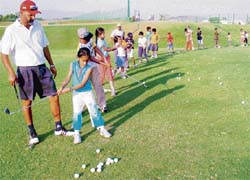 Jesse Grewal teaches the swing to little golfers at the CGA Golf Range in Chandigarh