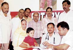 Doctors examine a child during a camp at Sood Hospital, Ahmedgarh, on Sunday.