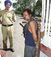 The man, who was allegedly caught stealing electric wire, tied to the main gate of Guru Nanak Dev Thermal Plant in Bathinda on Sunday.