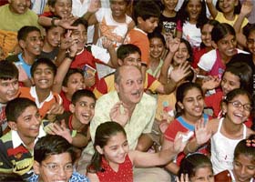 Anupam Kher poses with children who had gathered to hear him speak on books and reading at the British Library in Chandigarh
