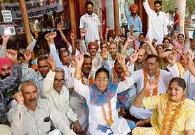 Members of the Haryana Rajkiya Kala Adhyapak Sangh raise slogans against the state government in support of their demands in Chandigarh