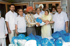 Officer-bearers of Manav Bhalai Manch distribute ration to 45 needy families in Amloh, on Monday.