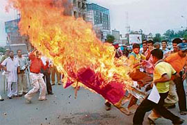 Protesters burn an effigy of Rajasthan Chief Minister Vasundhra Raje in Jalandhar on Monday.