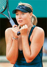 Maria Sharapova of Russia reacts after beating Switzerlands Patty Schnyder in the fourth round of the French Open in Paris on Sunday. Sharapova won 3-6, 6-4, 9-7.