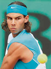 Rafael Nadal of Spain eyes the ball during his fourth round match against Lleyton Hewitt of Australia at the French Open in Paris on Monday. Nadal won 6-3, 6-1, 7-6.