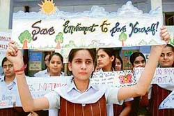 School students hold posters on the occasion of World Enviornment Day in Amritsar