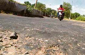 A potholed roundabout of Sectors 27, 28, 29 and 30 with stones scattered on it speaks about the deteriorating condition of Chandigarh roads