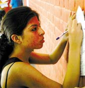 A student fill up an admission form at Delhi University in the Capital on Thursday.