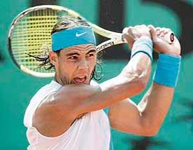 Spains Rafael Nadal returns the ball to compatriot Carlos Moya at the French Open in Paris on Wednesday. Nadal won 6-4, 6-3, 6-0. 