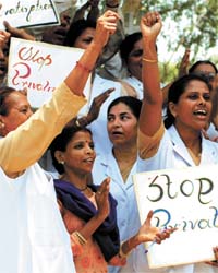 Nurses and health employees from various hospitals of Delhi demand better facilities at a rally near LNJP Hospital in the Capital