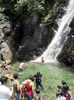 Local people and visiting tourists cool themselves at a waterfall near McLeodganj to beat the heat.