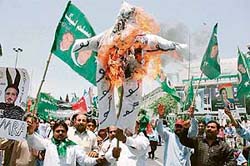 Activists of opposition Alliance for the Restoration of Democracy (ARD) burn an effigy of Pakistan President Pervez Musharraf to protest against a government crackdown on Opposition and media in Lahore