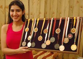 Nimrat Batra shows medals won by her in various competitions. 