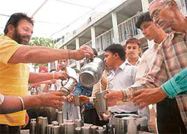 Sweet water being distributed in Sector 17, Chandigarh, on Friday.