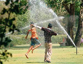 Youngsters beat the heat by coming in the line of a fountain crossfire at the Rose Garden, Sector 16, Chandigarh, on Friday.