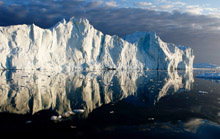 Icebergs are reflected on the water's surface near Jakobshavn fjord, Ilulissat. Greenland's ice cap is melting, and faster than scientists had thought possible. If the ice cap melted entirely, oceans would rise by 23 feet, flooding New York and London, and drowning island nations like the Maldives.  Reuters