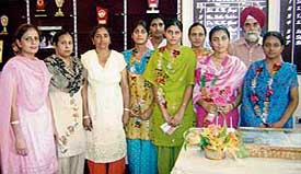 Meritorious students of Mata Hardei School after being honoured by members of management of National College Machhiwara on Friday. 