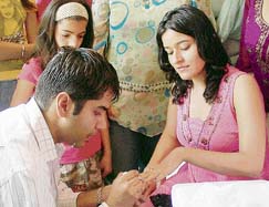 An artist of VLCC paints the nails of a girl during the summer camp being organised in Satluj Club, Ludhiana.