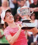 Belgiums Justine Henin holds the trophy after beating Serbias Ana Ivanovic in the French Open final at Roland Garros in Paris