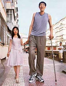 Bao Xishun (56), a 2.36-metre (seven feet, nine inches) herdsman, who has been listed by the Guinness Book of World Records as the tallest living man, walks with his bride, Xia Shujuan (29) in Chifeng, north Chinas Inner Mongolia Autonomous Region
