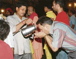 A man serves water at the scene of disaster.