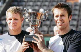 Mark Knowles (left) of the Bahamas and Daniel Nestor of Canada hold the trophy after defeating Lukas Dlouhy and Pavel Vizner of the Czech Republic 2-6, 6-3, 6-4