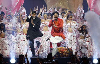 Amitabh Bachchan and his son Abhishek Bachchan dancing during the IIFA awards ceremony at the Hallam Arena in Sheffiend, Norther England, on Sunday.