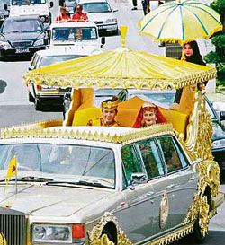 The royal couple, Pengiran Khairul Khalil and Brunei Princess Majeedah Nuurul Bulqiah, leaves the Nurul Iman Palace gates for a street procession in Bandar Seri Begawan.