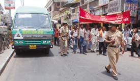 Man versus Machine: Rickshaw-pullers demonstrate in protest against the new CNG bus service at Chandni Chowk in the Capital on Monday.
