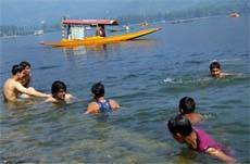 Beating the heat: With the mercury soaring, young boys choose the traditional ways of beating the heat  a dip in the Dal Lake in Srinagar on Monday.