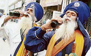 Nihangs take cold drinks to beat the heat in Amritsar on Monday