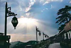 The sun peeps through the clouds, presenting a captivating sight in Shimla