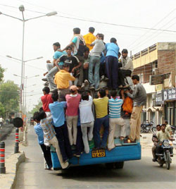 People hold on dangerously to a Haryana Roadways bus, unmindful of the fact that it poses too great a risk to their lives, at Sonepat on Tuesday.