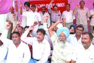 Members of the BSNL Employees Union and National Federation of Telecom Employees stage a dharna outside the BSNL office in Jalandhar on Tuesday.